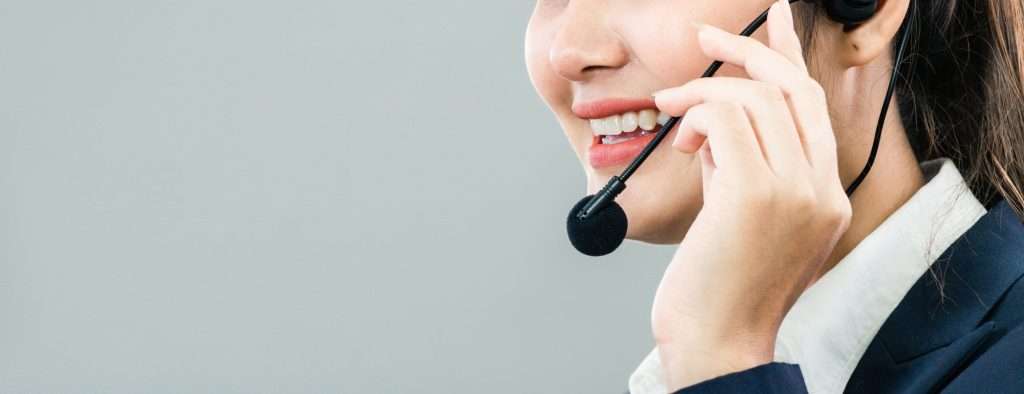 female-call-center-talking-with-customer-at-desk-2021-08-30-15-41-39-utc
